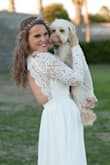 I had a wedding dress that I wasn't in love with so I was browsing online and came across a ton of options at Lulus. I wanted a beachy, bohemian look, but that look comes with a hefty price. I saw this dress online and it looked perfect for my upcoming January beach elopement in San Diego. I ordered it Tuesday night at 11pm, and it miraculously arrived Thursday at 10am- two days before my wedding!
I never have luck buying clothes online, but I was so in love I knew I had to take the chance. It paid off! The dress is gorgeous! I am average build and not curvy at all, but it looks stunning! The dress is not sheer and has some weight to it. The skirt is three layers, so no peek-a-boo of your rear. The crochet sleeves are sturdy and not tight even though I have chubby arms. The chest had room for a backless push up bra, but it was tight enough that I could have gone without one. I am 34DD, and I can see ladies with a smaller chest having an issue with the plunging neckline.
I'm pretty short, and I knew I would have to hem the dress as I planned to go barefoot on the beach. Much to my surprise, it wasn't super long. I opted to shorten it using hemming tape (no time for formal alterations). Now it's perfection! - Leslie K.