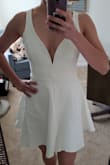 I followed some reviews saying you should order a size up and I am happy I did. I am mostly a small in "Lulus size" but the medium fit just right. I'm glad there are no breast cups attached to the dress, because they tend to be somewhat large, instead, there's a frame that will prevent accidents. The fabric is forgiving for being thick and elastic. There's a light skirt underneath. - Gracieli