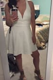 Beautiful!! The material is really thick so it isn't see through at all in white. I am usually a medium in other stores but the larges at Lulus have been fitting me better. This fits perfectly. The slip underneath is a bodycon fit so you feel more comfortable with the very wide flowy skirt. The deep v neckline is deep enough that you'll need a U-plunge backless bra, that's what I plan to get for this dress. The outer straps in the back go out pretty wide so I may have a seamstress move them in towards the middle of my back. I don't have a wide back so that might be better on someone else. I can't wait to wear this for my bachelorette party in August! - Rachel M.