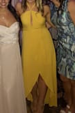 I wore this dress to a wedding last weekend and absolutely loved it!! I was nervous ordering online, especially since I typically don't wear yellow or dresses in this style, but ended up LOVING it and have never gotten more compliments on a dress. I thought the dress would be silkier but that's on me for not looking at the materials. It was a little confusing to get on at first and I really had to play with how tight I tied the strings and how tight I pulled the actual wrap. It was a lot looser across my chest on one side and was gaping before I pulled it tight and then tied the strings tight to secure it. I planned on wearing boob tape and nipple petals but ended up forgoing both and had no wardrobe malfunctions! It was so comfortable to dance in and I didn't have to fuss with it all night. I typically wear a medium or 6/8 in dresses and this medium fit perfectly. - Taryn S.