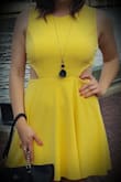 Positives begin with the color which is a pale, and not jarring, the shade of yellow. Although the cutouts do reveal the bra- it wasn't too noticeable with a tan bra. However, the negatives outweigh the positive, and I didn't enjoy this dress. I felt like a large oversized lemon- and part of that may have been my fault for ordering an L instead of M. It was a hard cut to pull off, and difficult to pair jewelry with to break down the solid yellow. - Virginia F.
