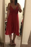 I purchased several dresses looking for the perfect look as a guest to a wedding on a beach in Mexico. This dress is so perfect! It's a wrap dress, but the wrap is very easy. The length is great! It's got the length in the back and has the flirty opening in the front without having the problem of feeling like your panties might show. I also love where the sash sits to cinches the waist! The reviews state that it doesn't work for many people's breasts - I would definitely agree that it has a wider cut, however, my breasts tend to sit wider anyway so it works out in my favor. This dress is definitely a more red-ish pink, but still makes me feel like the dancing emoji girl! Love it. - Kelly D.