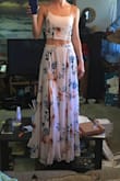 I was looking for a cute 2 piece maxi dress and this definitely qualifies. I'm a very petite person but zipped up the skirt actually stays above my hips and the top is adjustable in the back, fits me when I have it completely tightened. I'm planning on getting it hemmed since it is about a foot too long for me and have the top adjusted a little so you can actually see the pretty lace up in the back. I think it'll be worth it to get the alterations done. Color is not as dark of a peach color in person, much lighter, but I don't mind that. My first order of this had a hole in it but Lulus was quick to send me a replacement. Looking forward to wearing this to a friends wedding this summer and hopefully I can come up with other ways to show it off, possibly dinner date with denim jacket. Would've given it more stars if it fit without having to alter it, but since I'm so short I sort of expected it to be way too long. - Alysha P.