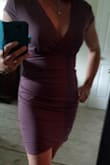 I really love this dress! The fit was a little loose and I probably could have gone down a size, but since it was on clearance I couldn't. The gathering on the side helped hide any problem areas and the neckline showed just enough cleavage without being tacky. The mauve color was a little more purple but that was perfect for me. - Elizabeth M.