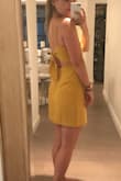 Such a nice dress, wore it on my birthday and I received compliments all night. It has a straight fit which makes it flattering but it is not tight fitting on the hips (it a-lines slightly) like a bandage dress so it's not tacky or too clubby at all. You can definitely dress it up or down. Other reviews mentioned you can wear a bra with this dress... unless you want to look trashy or poorly put together, this is false!! You can absolutely see a strapless bra at the back of this dress when you tie the fabric together. I went bra-less and since it's a high neck I felt totally comfortable! The fabric isn't too thin and the color is as pictured. Highly recommend - Samantha D.