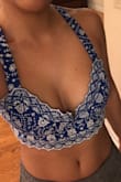 I do have to agree with the other reviewer. This top just doesn't fit as well as I thought it would. I don't feel like there is much support for bigger chested girls but there is also too much space for smaller chested girls. It's like a weird fit. I'm taking these photos with the back crossed which is supposed to cover it up even more, and it's still pretty loose. When I bend down there's a huge gap in the middle. - Janalys
