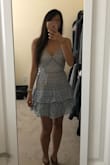 This dress is so flattering and adorable! It looks great in my petite frame. However, it is a little tight around the waist and there is no stretch at all, so if you're between sizes I would size up. The XS feels a little tight but it still looks great so I'm going to keep it, but I'm sure the S would've been fine as well. - Sara W.