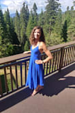 Wore this dress twice for graduation and as a wedding guest. Great dancing Dress. Only downside is if you have a small chest, then you have to tie the top pretty tight then the dress becomes very snug around the rib cage. Somewhat fixed this by tying the top of the straps together in the back with a hair tie to allow a looser fit around the rib cage. Can wear with or without a bra, would recommend a plunge-bra if you do. Dress is brighter blue than in the website picture. - Kat P.