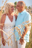 I purchased this dress for my 25th wedding anniversary. It is not a bright white it is more of a cream white and it was perfect. 
Brought it to the cleaners for a pressing and didn't have to alter it at all. It is a great summer dress!! - Lisa T.
