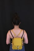 I've always wanted a little backpack to replace my sidebags / purses. I bought this last minute for my Vegas trip and it was so useful. It matched with all my outfits and was easy to carry. If you're really wondering how big the inside is, three 16.9 fl oz. water bottles fit inside, so its pretty spacious! 

The only downfall I would say is that it doesn't really stick to your back like a regular backpack would. It kind of hangs off your back a little, but its still comfortable. - Anne L.