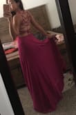 I just tried this dress on today. I really love the material. It's very flowy, heavy enough and has 2 fabric layers. It's so beautiful but the only issue is it's quite difficult to put on. It took me a while to figure out that I have to remove all the straps at the back before I can fit through it. You definitely need someone to help with the back straps. - Silvia V.