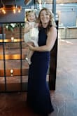 I wore this dress to a wedding this past weekend and it was incredible! I have a very large chest and am on the thinner side everywhere else. I was able to find a bra that I could wear as a halter (the straps connected close to the center of my chest - otherwise, with a regular strapless halter bra they would have showed). This dress is very comfortable and the material is the kind that doesn't wrinkle but isn't too heavy either. I did not have to iron this dress at all. I did have to have it hemmed just so slightly even when wearing heels. The bottoms flares out a bit which gives it a more sexy feel. The back is stunning! I got a ton of compliments on this dress. I will definitely be wearing it again! I paired it with some simple drop earrings and gold bangles. - Chelsea M.