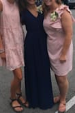 I loved this dress! It is very well made and a pretty blue. The slit hit in the perfect spot, but I sewed the top together to prevent it from falling open. It was a little big in the waist & I wish it was a little longer, but I overall loved the way it looked. I wore it to a family wedding & received many compliments! 

Pictured in the middle. - Lucy C.