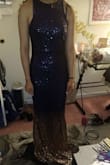 Bought this for a friend to wear for her graduation party, ultimately it was too long for her to wear even with heels but it looked stunning on and is worth hemming if you have the time before the event! The picture is in a dark room but the navy is a true dark blue that fades to a really pretty gold. - Brittany I.