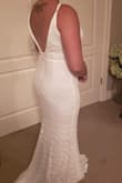 This dress is perfect for my backyard wedding! It's so flattering and almost gives me an hourglass silhouette even though I'm not curvy at all (very "athletic"/rectangular). The large is pretty snug on me but it's stretchy enough that it's still super comfortable. The top/bust part is relatively roomy, I think it could accommodate a much larger bust size (I have the straps tightened all the way). It's super long as seen in the pictures but this allows me to alter it with a train so it's perfect.  The lace is maybe not the highest quality and needs to be handled with lots of care (snags very easily), but for the price point the quality exceeded my expectations. - Breeann M.