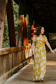 I wore this dress for my summer engagement photos, and it was a huge hit! The dress fit true to size, but it is a tad bit long on the bottom. I fixed this by wearing wedge sandals, so no problem! I'm very happy I bought this dress, I love the beautiful yellow color, it is flowy, feminine, and flattering! - Shari L.