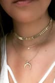 It looks exactly as pictured, I have super sensitive skin when it comes to jewelry but this didn't bother me at all. This necklace is actually two pieces so you can take the choker part off if you don't want such a bold look all the time. Amazing Necklace! Buy it! - Gloria B.