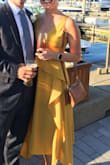 I love this dress. I wore this dress to a wedding in Newport, Rhode Island a couple weeks ago and received a ton of compliments on it! It is incredibly flattering and comfortable and the mustard/marigold color is really trendy right now. One thing to keep in mind is that you really can't wear a bra with it so make sure you have pasties.
I ordered a size small and it was a tiny bit loose in the shoulders. So maybe size down if you are between sizes. - Harmony H.