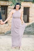 This dress runs small if you're busty! It does have a purple/dusty lavender hue to it, but it's super beautiful, light weight, and flowy. I got a lot of compliments on it. I wore it for my engagement pictures! - Breanna J.