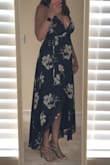 I absolutely adore this dress. I'm 5'10" and typically have a hard time finding maxi dresses that are long enough, but because of the high/low cut of this dress, I was even able to wear heels. This dress is very revealing in the chest area, so if you're not comfortable with that, you'll need to think of ways to cover up a little. I was showing a little more than I would have liked, but loved the dress so much I just went for it. I highly recommend this dress and received many compliments at the wedding I wore it to! - Shannon W.