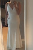 So, when I started wedding dress shopping, I was looking for something simple, modern, with little to no bling on it. I ended up buying a lacy fit and flare dress, but still wanted something close to my original vision to use for engagement pictures. This fits the bill COMPLETELY. I was pleasantly surprised at the quality of this item - it has a great weight to it, and has some stretch. I usually wear between a 4-6 and the M fit really well. It's super comfortable and has a hint of a train. It would function really well as a wedding dress, especially for a smaller, intimate wedding, an elopement, or a beach wedding. Seriously, it's pretty amazing! - SJ S.