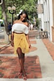 This skirt hugs at your waist and provides a slim look. It bunches at the top to give an illusion that it is tied- well it does have a little tie feature haha. It is light, and wearable in the hot summer days in Florida, and since it is yellow, this is easy to wear in the Fall as well- again in Florida. Beautiful all around. - Solange G.