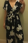 This romper runs a little big, but I'm always worried with my cup size that a smaller size won't fit. If I want to wear it to the office / work, I slip a shirt under it to make it less booby. Fun for a night out though! Tie the bow tight to make it look a bit less baggy. Not returning, been wearing it a ton. - Emese A.