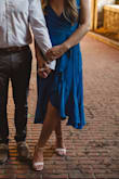 I love this dress so much - wore it for my engagement pictures. It flows nicely and feels like a nice thick material - not see through at all. If you have a larger bust, I would definitely order a size up. 

I wore petals and used double sided sticky tape. I recommend Fashion Tape - I usually use this, but I bought a cheap kind from target when I wore this dress and it didn't stick well to the underside. - Sarah B.