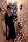 After reading the reviews on here, I decided to purchase this dress myself. It took about 2-3 days to arrive. Although at first I thought it was a bit pricey for a dress I can probably find at forever 21, the quality of this dress is a LOT better.  The cut and how it fits on me is good too. I purchase a size SMALL and there is still room. For reference, I wear Abercrombie size 6S jeans. If you wear size 4,6,8 for their jeans, a size Small will fit you. If you have a smaller chest, like an A cup or small B, it might be a little loose around the chest area. I am wearing a lightly padded VS bra which shows minimal cleavage. 

The slit on the size is very sexy too! I'm planning on wearing this dress to a wedding. I would recommend this dress! - Alice L.