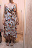 I ordered this lovely dress to wear to a friend's wedding and am very sorry it didn't work out for me.
The Pros:
The quality of the dress was good--sound stitching, beautiful pattern on a light-weight fabric that would be perfect for an outdoor summer event. The hi-low hemline is great for short people like me, as most midi or hi-low dresses tend to fit us petites like a maxi dress. The slit was sexy and showed the right amount of leg when walking without showing too much.
The Cons:
Since I am petite, but very pear shaped, wrap dresses appeal to me, as there is some room for adjustment. Unfortunately, this dress did not work for my body type. To be honest, I'm not sure it would work for many body types. The neckline was so low and wide open, it was almost like it was meant for someone with a long chest and a high waist if that makes sense. I have a broader rib cage and a lower natural waistline, so if I sized down to XS, the chest area might have been a better fit, but waistline would have been far too high for me. I even tried pinning the neckline or straps back, but since the fabric does not have any stretch and the actual cut of the neckline is just so, these simple adjustments did not prove helpful.
Conclusion:
If you're someone with a high waistline and a larger chest area who doesn't mind showing a whole lot of that chest, this could be a lovely dress for you. - Nichole P.