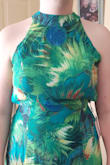 I gave it three stars because I had to fork more money to tighten the surprisigly over-excessive material that drooped from my waist up. I also had it hemmed but I knew that needed done before buying it. I chose not to size down because any tighter around my hips would've been uncomfortable. It's a flowy light material dress which is perfect on a hot day, the colors are eye popping as pictured and i received a lot of complements wearing it. Great to dance in with the open back. - Kelly C.