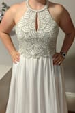 This dress is beautiful! The photos don't do the beading justice. There are little pearls along with sequins and rhinestones. The dress is very well made, and the straps are sturdy. The hem is too long for me and will need to be hemmed since I'll be wearing flats for my wedding, but that's the only tailoring it needs. Very happy! - Shelby D.