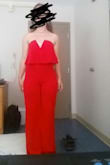 This jumpsuit is excellent - I was a bit concerned about the length of the torso but it fits flawlessly on the top half. I am bottom-heavy, and have thicker thighs/bum than my upper body/breasts so I always end up having to order a size that will fit my behind first. Often times this sacrifices the fit of the top if I order a dress or romper, but not in this case! The top half of the romper is flattering and stays up on my body easily. Great for dancing since it has rubber lining to keep the top in place. The ruffle detail is adorable, the color is as vivid as the photograph shows, and the deep v-neck maintains its shape with wiring, which doesnt sacrifice the comfort of the jumpsuit!!

Downsides? If you are similar to me, with a bigger behind and a smaller upper body, you may have to get this hemmed depending on your height. The medium is at least a foot too long in length for my legs, but the small would have been too tight/uncomfortable. In these photos I am standing in my tippy toes and it is still too long. For this reason, I gave the jumpsuit 4 stars. - Kathleen B.