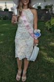 I wore this dress to one of my bridal showers and it was gorgeous! I received a ton of compliments. I was told by Lulus to order a medium but ordered a small and it fit perfect! It was comfy and not too tight in the slightest. The material is high quality. I recommend this dress. - Jazmine O.