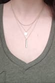 You can see from my photo that the shortest chain is quite a bit longer than the one in the product photo. I'm hoping that I'll be able to shorten it as I don't like how close and bunched up the chains look currently. - Chiara E.