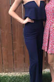 This fun little jumpsuit is very fun and flirty! The material is wonderful, it's very stretchy and the flowy fabric around the bust gives a very unique silhouette. Also I LOVE the navy blue color! - Hailey H.