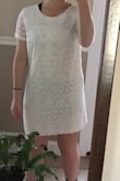 I got this dress for my confirmation and I love it. It fits perfect and isn't too short. It's at about mid thigh. It is see through though so make sure you wear nude or white undergarments. Very classy and well made. - Jaclyn C.