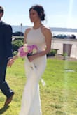 It looks exactly like the photo. Sleek and sexy. Material is thick and heavy and doesn't look cheap at all. I am usually a size 2 for dresses and size M fits like a glove. The stretch material really hugs my figure in a complementary way. Perfect dress for reception or civil ceremony. - Simin L.