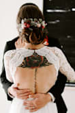 Absolutely stunning. We had an elopement ceremony and I originally set out with low hopes of finding something I fell in love it on short notice. Ordered this dress and as soon I put it on I knew my hopes had been far exceeded. The back of the dress is so flattering, paired with the sleeves it makes a timeless and classy with an edge. I had so many compliments, and even was featured on the wedding venues page because of the back of the dress. Would highly recommend! Had bottom altered for length because I am short, but am totally satisfied otherwise. - Kati C.
