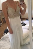 Amazing material, beautifully beaded, and fits wonderfully. It has a very long train and is long in general so I may alter a bit. Great price for such a beautiful dress! - Mackenzie S.