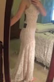 I really loved this dress, I've been eyeballing it and wait listed. It fit like a glove but I am very tiny. The white lace on the nude lining really is so pretty. The bottom says class but the top is quite plain. If this would have had lace sleeves for my winter wedding it would have been amazing. In the end it was just a bit more casual that what I'd planned for. I am still very glad I tried it because I wouldn't have stopped thinking about it. It's most definitely a lovely dress. - Chelsea C.