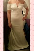 The dress fits better than I expected, but it is a bit too tight around the hips for my liking. The sleeves aren't abnormally tight, but they do restrict arm movement somewhat. Like the other dresses I've ordered from Lulus, this one needs hemming. Color is certainly not white, more like ivory/light cream, which is preferable in this case - bright white would look too cold with my skin tone. I will be hiding the waist seam with a belt, since it is a bit too noticeable. Overall I would recommend this dress, just be aware of the tighter fit compared to some other Lulus dresses. For the price I do think the quality is pretty good - the fabric feels heavier than I thought but it seems to wrinkle easily, and any imperfections show a lot more clearly through this fabric than for example lace. The top part is very pretty, and the V is well constructed. Will definitely be wearing this after making some small adjustments! - Katja T.