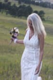 This dress was perfect for my summer meadow wedding, comfortable all day and easy to walk in. I received so many compliments and you will too!! I did have to have it shortened by three inches to wear with flat sandals but other than that it was a great fit. It is more on the ivory side than white due to the beige under lining that shows through the lace but that is what I was look for color wise. SO happy I found this gorgeous dress for such a small price! - Laura