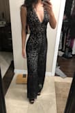 I love this jumpsuit! I was worried about the length because I am on the shorter side but with a cute pair of black heels it's the perfect length! It's very fitted for me from the waist up and I don't think I would need to wear a bra with this. From the waist down it's a teeny bit looser than I would have liked but it still looks great in my opinion! - Samantha N.