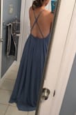 The color is a lot darker in person than it looks online. Also, the straps in the back are adjustable which is helpful but there is not a lot of fabric to cover side cleavage so instead my chest was just hanging out of the side. Also it was veryyyyyyyy long and is made for someone extremely tall. If you like revealing dresses then this is for you but if you need to be more covered up then I would not suggest it for you. - Sarah S.