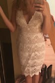 I really love this dress! I originally ordered a medium but that was too small on me. Lulus made it really easy to exchange for a large. I did have to purchase the large and then was refunded for the medium once they received my return, so be prepared for that if you exchange. 
The large is a little big on me. The under layer hugs but could be taken in a bit. I wouldn't mind, but since the lace is looser than the under layer, it is noticeable. Overall I am very happy with my purchase. - Harley J.