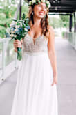 This dress was all I could have ever dreamed for in a wedding dress. I was reluctant to spend a ton of money on a wedding dress and knew if I went into a bridal shop I'd be emotionally conned into buyers remorse. When I saw this dress, I knew it was the one! On my wedding day everyone was giving me compliments and in absolute disbelief that I bought it online for such an affordable price! It felt and looks so romantic on and flows so beautifully when you walk and dance which is ideal for photos! Since I'm posting one professional photo, I need to disclose my photographer is EmaReide photography in San Antonio. - Brittany A.