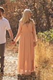 It is a really beautiful dress and worked well for family photos. The length is great for wearing heels. It is conservative, but a little flirty with the neckline and slit down the leg. It does run a little large. I ordered a Medium, but wished I had gotten the small. - Jaime A.