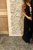 I ordered a size XS at first, but I wanted the dress to fall a little more softly on my waist, so I exchange for a S. I loved the back and got numerous compliments on it. The picture looks quite dark, but it's a very apparent navy in real life. It was the perfect length with 4 inch heels (I'm 5 ft 4). I had to put double stick tape on the chest area, but it could be worn without, depending on your preference. - Connie S.