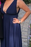 I wore the dress for an evening wedding and I was absolutely in love. For sizing I followed the chart, upon opening the package the dress looked huge but fit like a glove. A little revealing in the bust and I used double sided tape. Sorry I can't crop the photo correctly, I personally use the reviews and photos to help with purchases. - Vaitiere S.